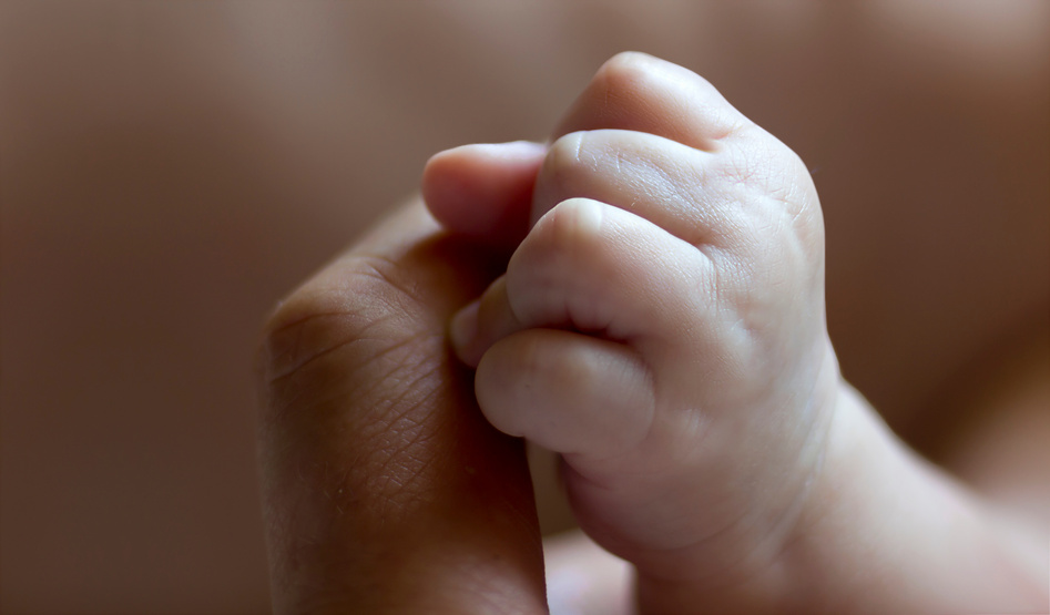 Baby hand on a men's finger