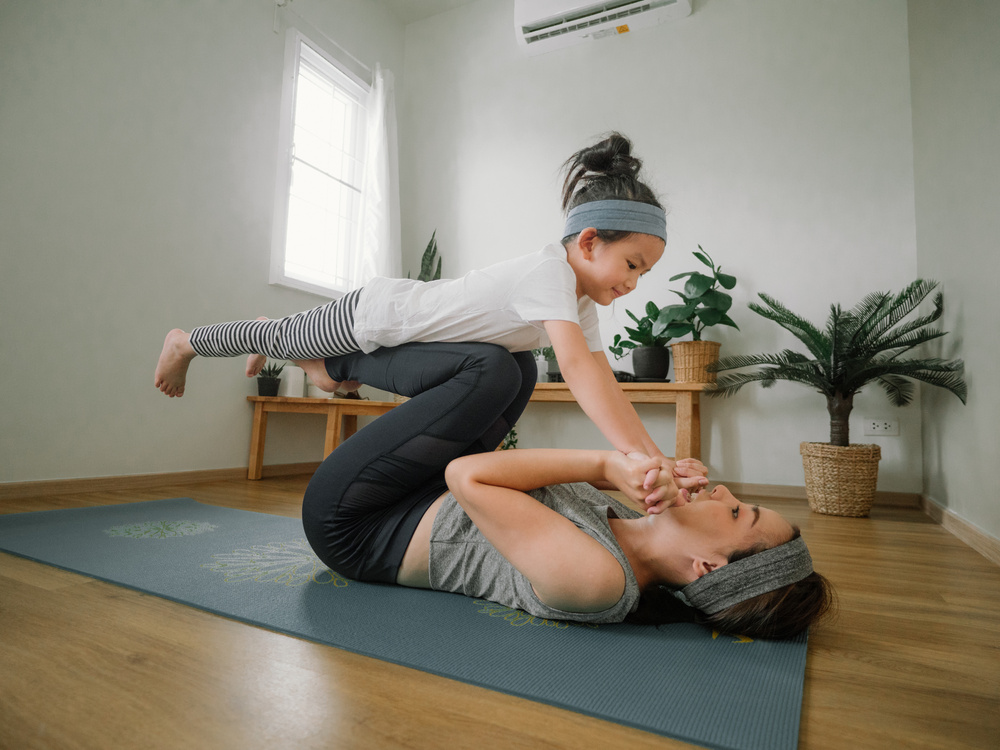 Mother and daughter doing yoga