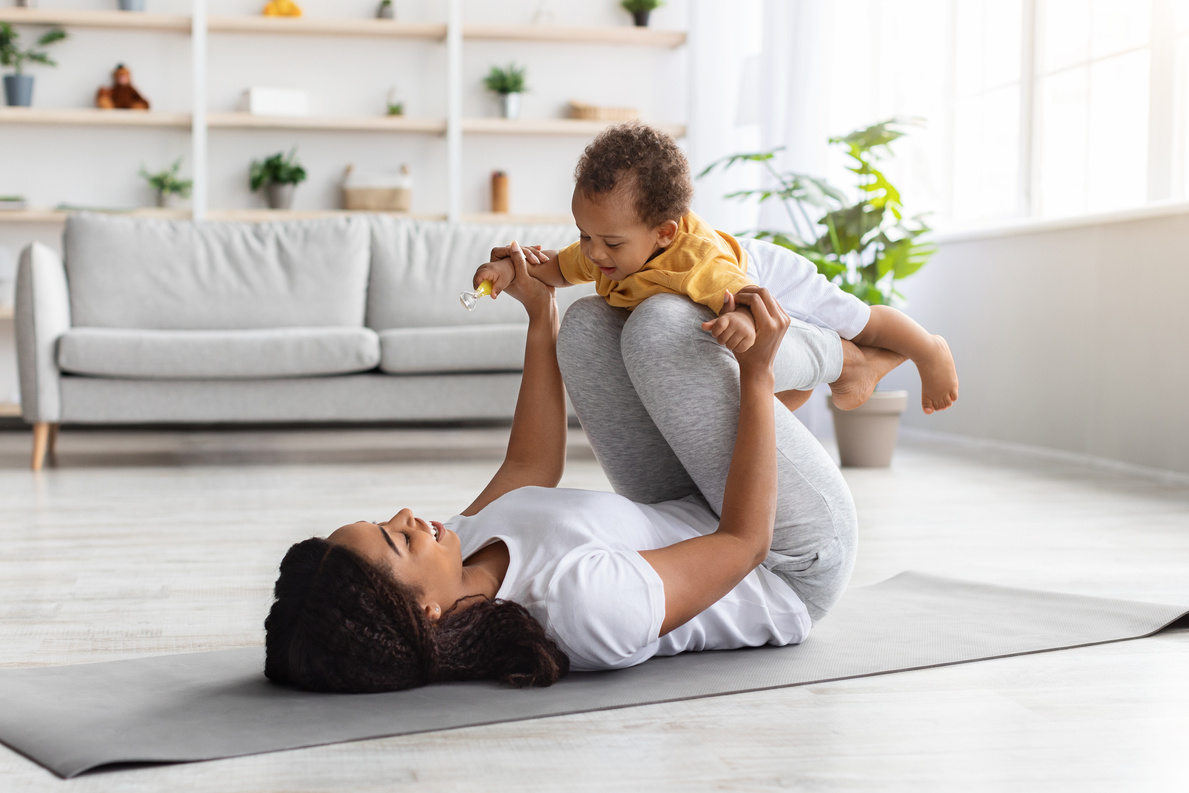 Sport Activities with Baby. Black Mom Exercising with Infant Son at Home